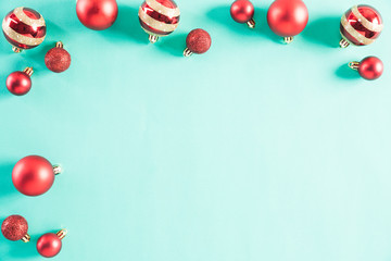 Christmas holidays composition Top view of white picture frame with Christmas tree decoration and red berries on green pastel background with copy space for text.