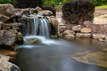 Naklejka na ściany i meble Rock waterfall with pond
