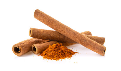 cinnamon sticks stacked and powder on white background
