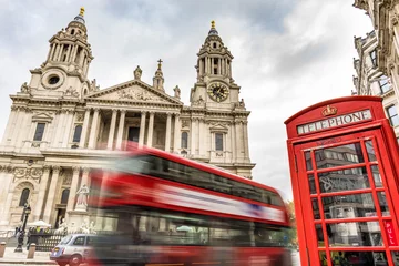 Foto op Plexiglas red phone boxes and red bus passing Saint Paul's Cathedral in London at cloudy day © offcaania