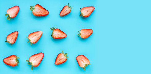 Ripe strawberries on blue background.