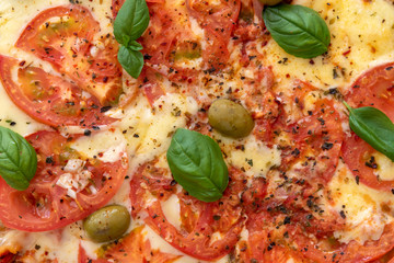 Freshly made wood fired pizza viewed from above on rustic turquoise boards