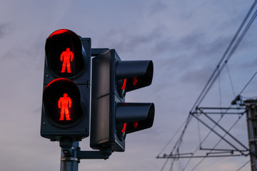 Close up view of red traffic light at level crossing railway barrier, and blur outdoor background...