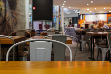 Close up and selected focus view at rough metal chairs in dining room of restaurant with loft...