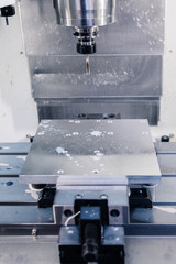 Metalworking CNC milling machine. Cutting aluminium parts in modern processing technology.