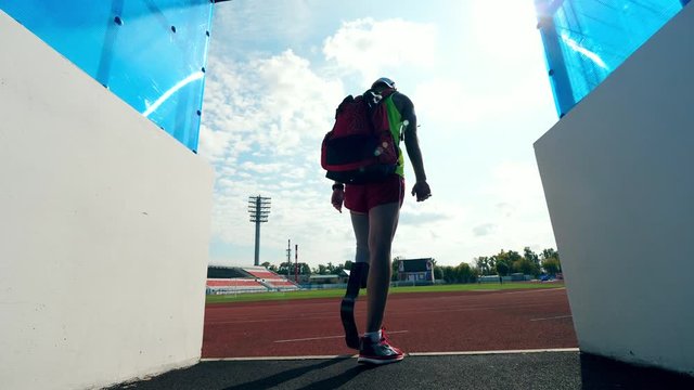 A man with a prosthetic leg is entering the stadium