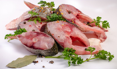 Fish steak with spices on white background