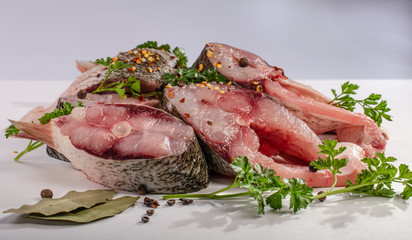 Fish steak with spices on white background