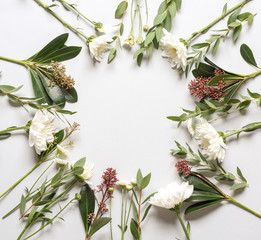 Composition with autumn flowers and leaves on white background