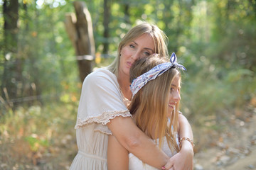 Mother and daughter hugged and relaxed in a forest