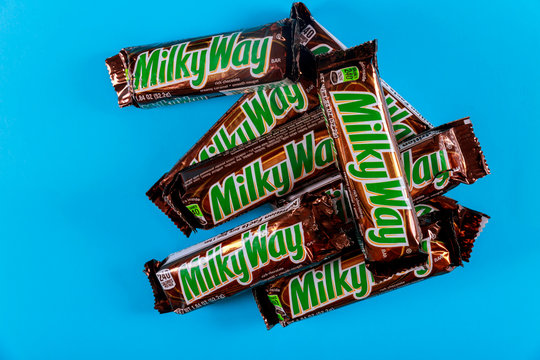 Milky way chocolate candy bars is are produced by Mars Incorporated. in 1923 on blue isolated background