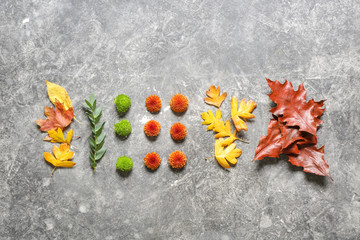 Composition with autumn flowers and leaves on grunge background