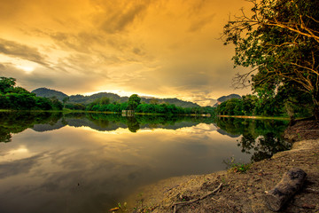 Natural background of a large reservoir in Krabi,Thailand(Nong Thale)atmosphere surrounded by mountains,trees of various sizes, blown through the wind,blurred cool during the day,a viewpoint of travel