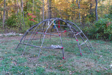 Primitive Sweat Lodge Shelter made with birch saplings. Bushcraft survival shelter for spiritual ceremonys. Similar to sauna / steam room.