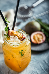 Fresh tropical cocktail with orange, peach and passion fruit
