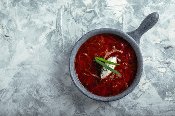 Traditional Ukrainian Russian vegetable soup, borsch with garlic donuts, pampushki on a white wooden background