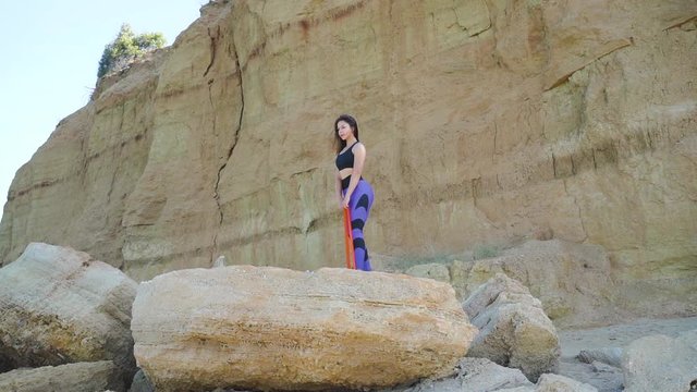 Young adult and sporty girl training with espander outdoor