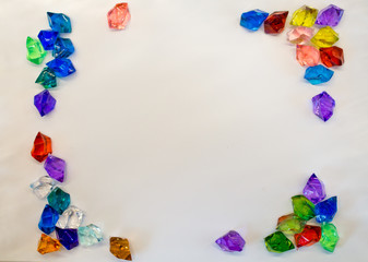 Square frame from multi-colored stones on a white background. Handmade.