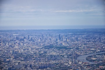 Naklejka premium Aerial view of Bangkok Thailand and surrounding landscape, modern office buildings, condominium, living place in Bangkok city downtown in the most populated. Southeast Asia.