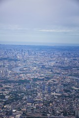 Aerial view of Bangkok Thailand and surrounding landscape, modern office buildings, condominium, living place in Bangkok city downtown in the most populated. Southeast Asia.