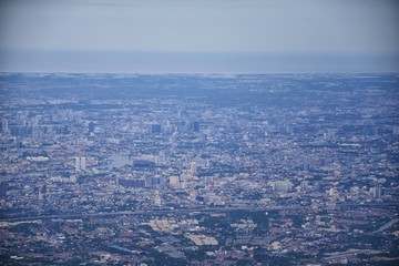 Fototapeta premium Aerial view of Bangkok Thailand and surrounding landscape, modern office buildings, condominium, living place in Bangkok city downtown in the most populated. Southeast Asia.
