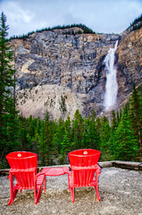 Two chairs set up outdoors with view of Takakkaw Falls in Banff National Park in Alberta