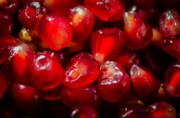 Red seeds from pomegranate. Fruit background.