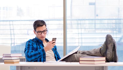 Student studying in the empty library with book preparing for ex