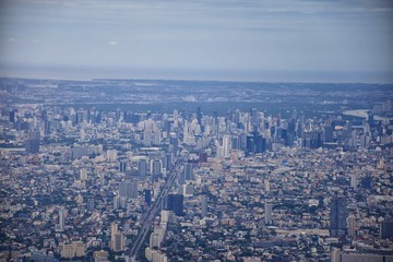 Fototapeta premium Aerial view of Bangkok Thailand and surrounding landscape, modern office buildings, condominium, living place in Bangkok city downtown in the most populated. Southeast Asia.