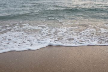 Sandy beach and soft wave of the sea