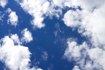 Blue sky with cumulus clouds. Beautiful sky background for design and advertising.