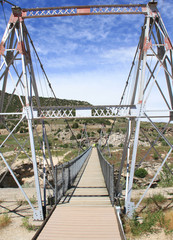 Suspension pedestrian bridge over river at Hot Springs, Thermopolis Wyoming