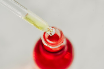Drop of oil, serum in a dropper closeup. Skin care concept.