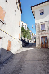 Fototapeta na wymiar Narrow steep street with old houses in the old part of the San Marino city