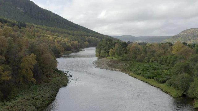 Aerial view of the River Dee near the Scottish town of Ballater in the Cairngorms National Park, Aberdeenshire. Low elevating view from above the river.