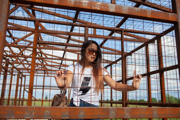 Girl in a cage behind bars