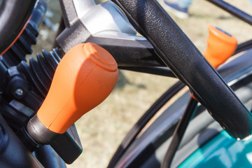 Operating control panels or levers and steering wheel in forklift
