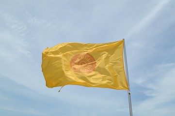 buddhist yellow flag on blue sky