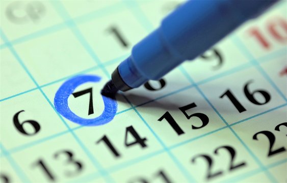 7th – Seventh Day Of The Month. The Woman Marks The Calendar Date With A Blue Marker. Business Wall Calendar Planner And Organizer