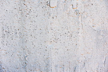 Texture of a concrete wall with cracks and scratches which can be used as a background
