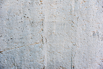 Texture of a concrete wall with cracks and scratches which can be used as a background