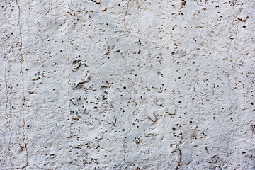 Texture of a concrete wall with cracks and scratches which can be used as a background