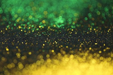 Wallpaper phone shining glitter. Christmas Festive background. Gold and green glitter macro background with shining bokeh on a black background. Shining texture