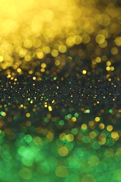 Wallpaper phone shining glitter.New Year and Christmas Festive background. Gold and green glitter macro background with shining bokeh on a black background. Shining texture