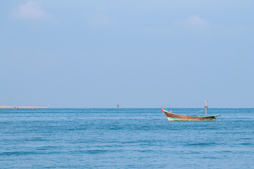 Fishing boats on the sea with blue sky background.Bang Saen Beach,Chonburi district,Thailand.	