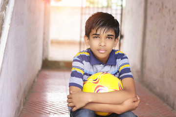 Portrait of Indian boy holding the football