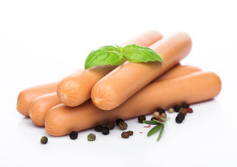 Classic boiled meat pork sausages with pepper and basil on white background.