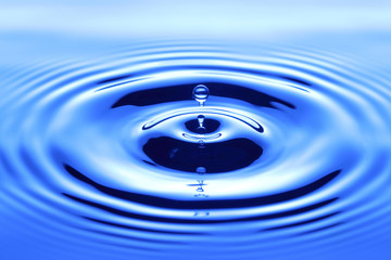 Splash of drop water in blue tone, blank spce from above to create concepttual.