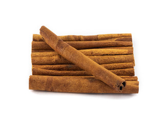 Neatly folded cinnamon sticks on a white background