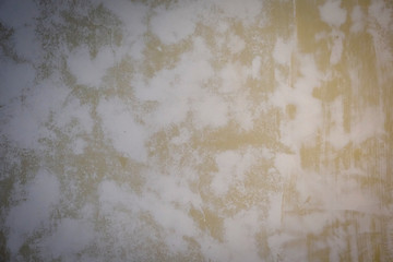 Yellow cement wall background picture  With a pattern that is white and uneven